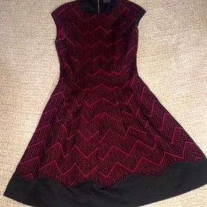 This is a Versona brand dress, size 2, and it’s deep red and black.